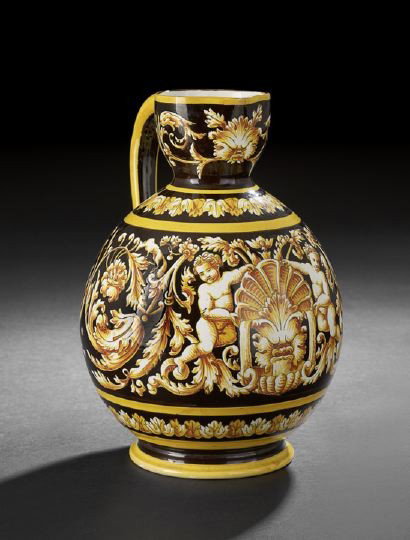 French Faience Wine Jug in the Baroque Taste,: French Faience Wine Jug in the Baroque Taste, fourth quarter 19th century, decorated with putti planking a central shell, volutes on each side have birds nests nestled in their terminating medallions,