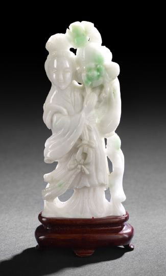 Chinese Carved Feicui Jadeite Figure of a Maiden: Chinese Carved Feicui Jadeite Figure of a Maiden, the standing figure clad in flowing robes and having a high chignon, the figure holding a peach and flowers on one shoulder, the pale mint green stone