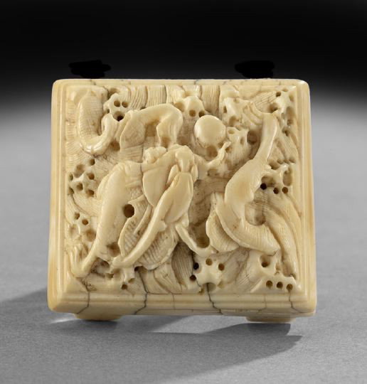 Chinese Carved Ivory Belt Slide: Chinese Carved Ivory Belt Slide, now with rings for use as a pendant, the nearly square slide with two slide openings on the reverse, the face carved in delicate deep relief with a dragon pursuing the