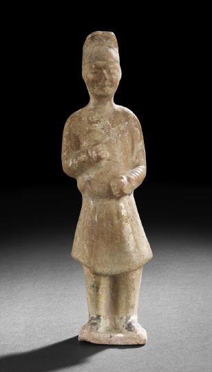 Chinese Partially Straw Glazed Tang Tomb Figure: Good Chinese Partially Straw Glazed Tang Tomb Figure, (618-907), molded as the standing figure of an attendant wearing a short tunic and standing on a flat base, the degraded straw glaze with a fine m