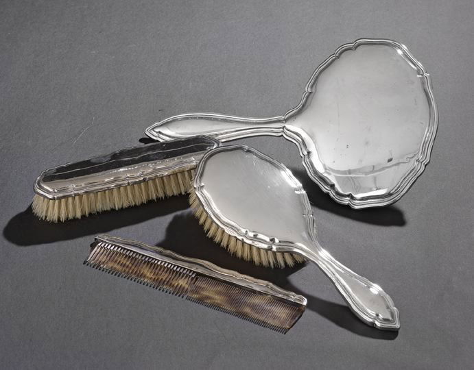 German .800 Silver-Mounted Four-Piece Dresser Set: German .800 Silver-Mounted Four-Piece Dresser Set, first quarter 20th century, by Johann Beck, Schwaebisch-Gmuend, including a hand mirror, l. 11-1/4", a hairbrush, l. 9-1/4", a faux tortoise comb, l.