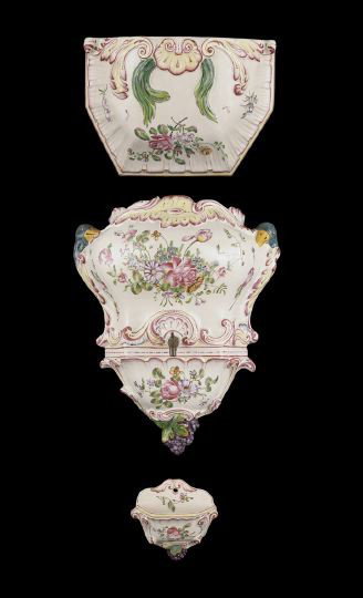 Two-Piece Faience-Style Lavabo and Shelf: Continental Two-Piece Faience-Style Lavabo and Matching Bracket Shelf, the components richly decorated with floral prays and grape motifs, tank h. 18", w. 16", d. 8", bracket h. 10", w. 15", d. 5".