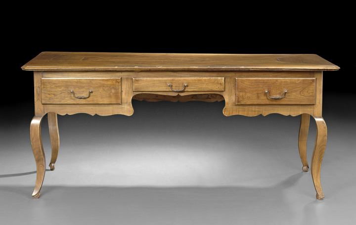 Provincial Louis XV-Style Elm and Fruitwood Desk: Provincial Louis XV-Style Elm and Fruitwood Desk, early 20th century, the rectangular top with molded edge and canted corners, above a frieze fitted with a central drawer flanked to either side by a s