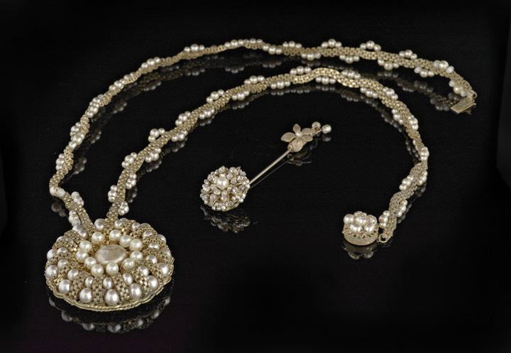 Two Pieces of Miriam Haskell Costume Jewelry: Two Pieces of Vintage Miriam Haskell Costume Jewelry, the necklace featuring a round pendant with a central baroque pearl surrounded by smaller pearls and a box-link chain design, the box-link chain e