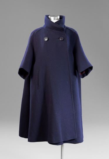 Navy Wool Twill Weave Swing Coat: Navy Wool Twill Weave Swing Coat, ca. 1940, attributed to Balenciaga, with a stand-up collar and covered snap closure, darts at the neck with two button closure, cropped sleeves and two slash pockets,