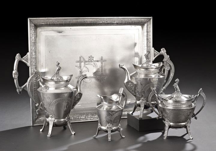 Reed & Barton Neo Grec Silverplate Tea Set: Reed & Barton Neo Grec Silverplate Tea Set with Aesthetic Pairpoint Tray, the tea set third quarter 19th century, Taunton, Massachusetts, including a coffeepot, h. 10-1/2", teapot, h. 10", covered sug