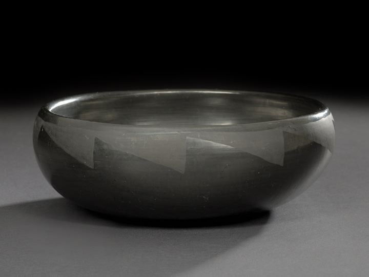 San Ildefonso Pueblo Black-on-Black Pottery Bowl: San Ildefonso Pueblo Black-on-Black Pottery Bowl, by Blue Corn, a.k.a. Crucita Gonzales Calabaza (1921-1999), the squat polished bowl decorated with matte lightning-banded rim, the base signed in sgra