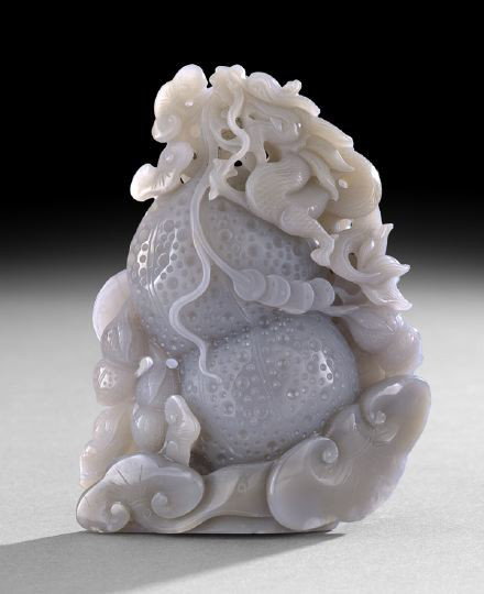 Chinese Carved Jade Dragon and Gourd Group: Chinese Carved Jade Dragon and Gourd Group, 20th century, the even-colored gray stone carved as a large double gourd on a base of ling-chih with peanuts at the side, the gourd carved with a dragon cli