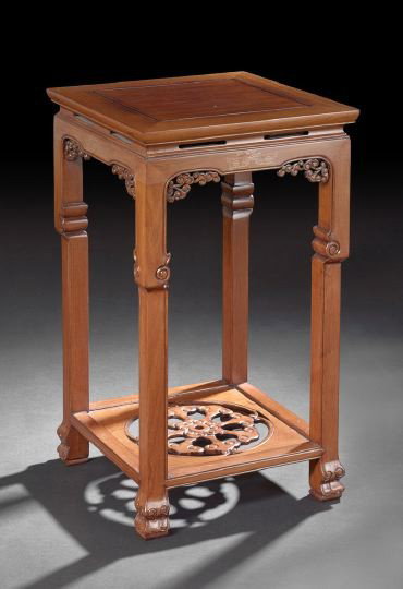Chinese Rosewood Squared Plant Stand: Chinese Rosewood Squared Plant Stand, 20th century, the squared top with a floating panel supported on reeded square legs with carved feet, a shaped foliate apron and a lower shelf with pierced floral