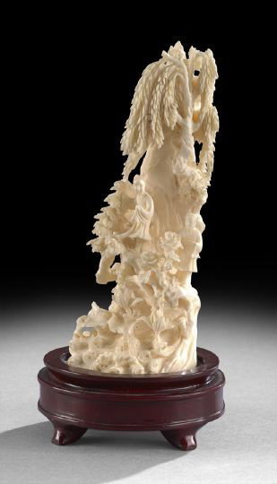 Intricate Chinese Carved Ivory Landscape Group: Intricate Chinese Carved Ivory Landscape Group, 20th century, intricately carved in high relief as a rocky outcrop with willow trees above a lotus pool, carved with two figures gathering flowers, wood