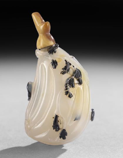 Unusual Chinese Carved Agate Snuff Bottle: Unusual Chinese Carved Agate Snuff Bottle, of pale gray agate carved as a ribbed fruit with jet black inclusions carved in relief as leaves and two bats, h. 2-1/2".
