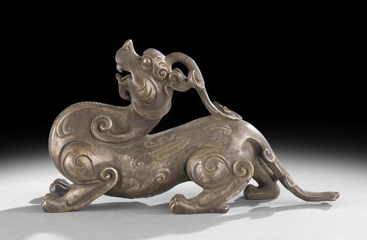 Chinese Brass Sculpture: Chinese Brass Sculpture, depicting a dragon with its head thrown back, the body is relief molded with scrollwork, l. 9-1/2".