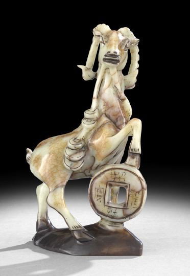 Chinese Jade Carved Figure of a Goat: Chinese Jade Carved Figure of a Goat, the mottled celadon and rust jade depicting a goat with one foot on a large "cash" symbol and holding a string of "cash" in his mouth, h. 12".