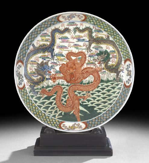 Chinese Famille Verte Porcelain Deep Dish: Chinese Famille Verte Porcelain Deep Dish, the raised geometric patterned rim centering an elaborate scene of three dragons in a stylized hill and cloud landscape, dia. 15-3/4".