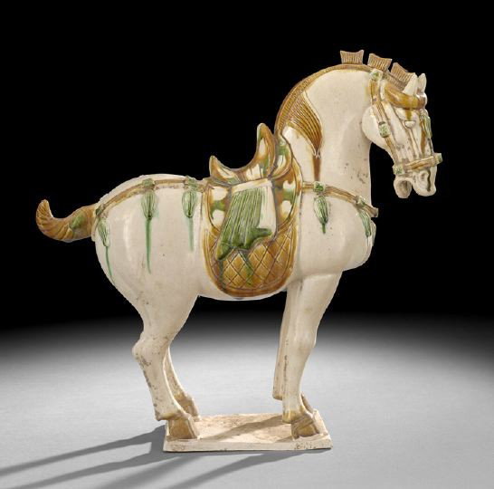 Chinese Sancai Glazed Figure of a Horse: Chinese Tang-Style Polychrome Sancai Glazed Terracotta Figure of a Horse, the horse saddled and with a decorative bridle, raised on a plinth base, h. 14-1/2".