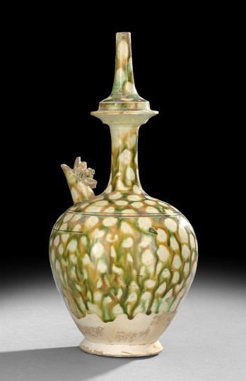 Chinese Tri-Colored Glaze Sprinkler Bottle Vase: Chinese Tri-Colored Glaze Sprinkler Bottle Vase, Tang Dynasty (618-907), the tapered bulbous body with a monster head spout and a thin tapered neck with a central encircling flange, glazed in a spotte