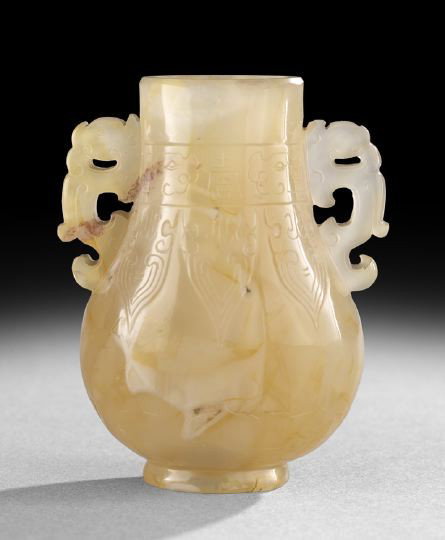Small Chinese Carved Agate Vase: Small Chinese Carved Agate Vase, 19th century, the mottled gray and brown stone carved in a flattened pear shape with archaic dragon handles, the body with engraved designs of archaic plantain leaves 