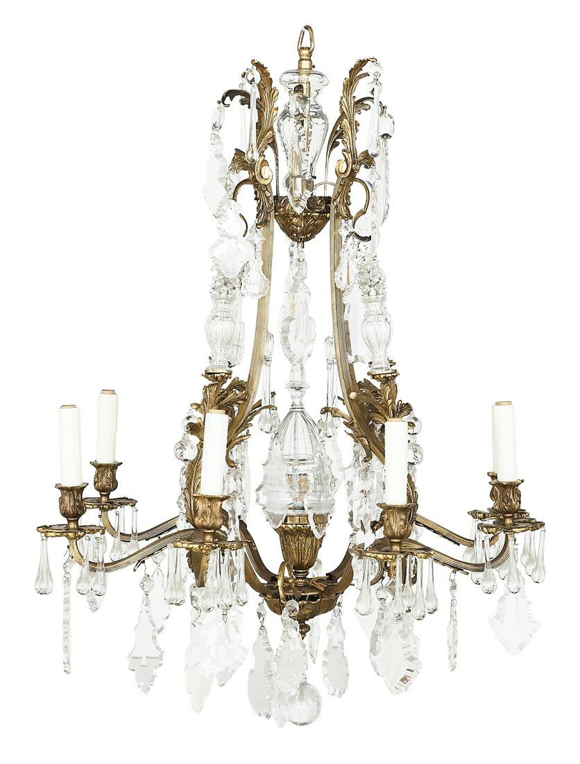 French Bronze and Crystal Chandelier: French Bronze and Crystal Chandelier third quarter 19th century, in the rococo taste, the nine-light chandelier with a reeded bronze frame ornamented with molded leaves, set with leaf-molded prism rin