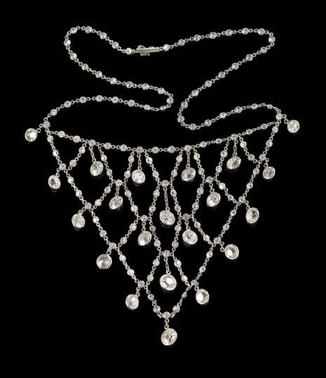 Fine Edwardian Platinum and Diamond Bib Necklace: Fine Edwardian Platinum and Diamond Bib Necklace, first quarter 20th century, comprising twenty one old European cut diamonds, 5.5 - 6.5 mm diameter and averaging J-L color and SI1-2 clarity, in "eyeg