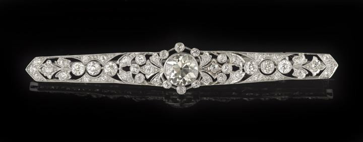 Fine Edwardian Platinum and Diamond Bar Pin: Fine Edwardian Platinum and Diamond Bar Pin, first quarter 20th century, centered by a large Old European cut diamond weighing approximately 4.25 cts., 10.1 x 6.8 mm, approximately J/K color and SI1 c