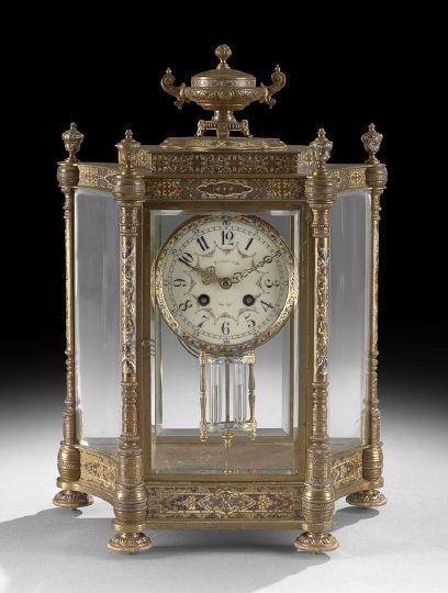 French Champleve Enamel Mantel Clock: French Champleve Enamel Mantel Clock, first quarter 20th century, retailed by Tiffany and Company, New York, the brass case with an urn finial resting on a platform, the rounded sided case in brass se