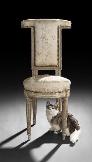 Louis XVI Creme-Peinte Voyeuse: Louis XVI Creme-Peinte Voyeuse, late 18th century, the padded rectangular crest and back above the elongated padded seat, raised on stop-fluted tapering circular legs ending in toupie feet, h. 34".