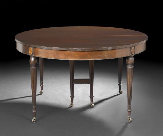 American Sheraton-Style Mahogany Banquet Table: American Sheraton-Style Mahogany Banquet Table, first quarter 20th century, the circular top opening to accommodate the six original eleven inch skirted leaves, raised on turned and reeded legs, h. 30
