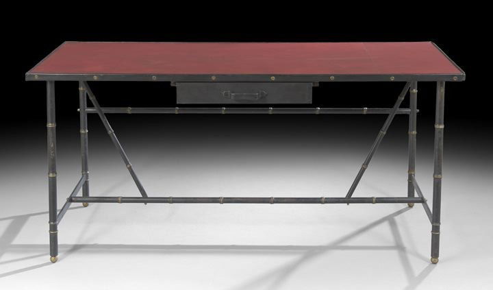 Jacques Adnet (French, 1900-1984) Desk: Jacques Adnet (French, 1900-1984), Leather, Steel and Brass Desk, c. 1950, the top edge black leather-wrapped metal with an inset crimson leather writing surface, fitted with a single black leather-cl