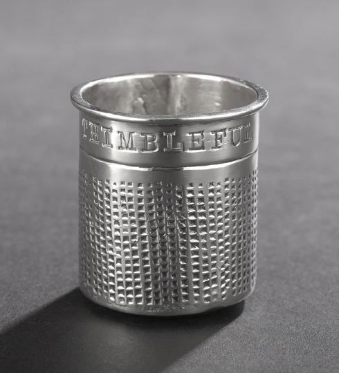 Mexican Sterling Silver Novelty Shot Cup: Mexican Sterling Silver Novelty Shot Cup, third quarter 20th century, by Uxmal de Taxco, in the form of a large thimble and inscribed "Just a Thimbleful", h. 1-3/4", dia. 1-5/8", 1.35 t. oz. By reputa