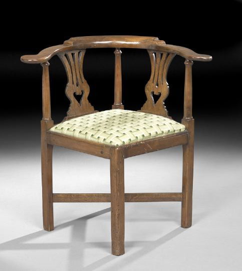 George III Fruitwood Corner Chair: George III Fruitwood Corner Chair, late 18th century, the rounded and stepped crest above two vasiform splats, the padded square seat raised on square legs joined by an X-form stretcher, h. 31".