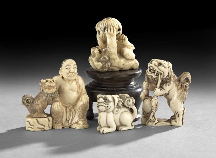 Group of Four Japanese Ivory Netsuke: Group of Four Japanese Ivory Netsuke, 20th century, three carved as shi-shi in various positions and one carved as a shi-shi seated with a partially robed monk, h. 1" to 2".