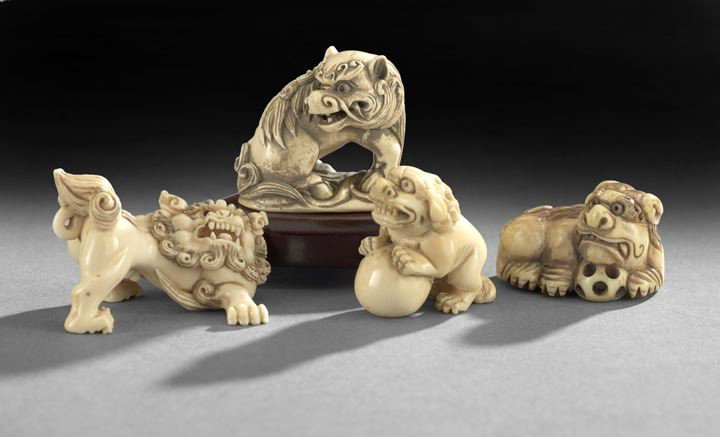 Group of Four Japanese Carved Ivory Netsuke: Group of Four Japanese Carved Ivory Netsuke, 20th century, each carved as a figure of a shi-shi, one holding a solid ball, one seated on its haunches with back-turned head, one holding an openwork bal