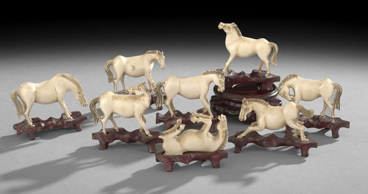 Ivory Carvings of the Eight Horses of Mu Wang: Group of Eight Chinese Ivory Carvings of the Eight Horses of Mu Wang, 20th century, each carved as one of the Emperor's eight steeds in a different pose, frolicking and resting, fitted wooden stands, 