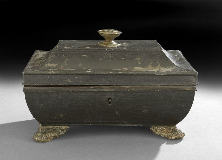 Regency Tole Jewel Box: Regency Tole Jewel Box, first quarter 19th century, molded brass paw feet support the sarcophagus-form body, the top mounted with a period Sheraton knob, the red painted interior fitted with a compart