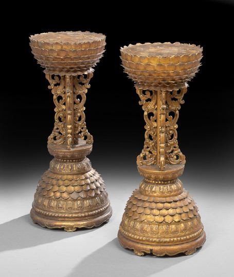 Pair of Southeast Asian Giltwood Pedestals: Pair of Southeast Asian Giltwood Pedestals, 20th century, each with a circular top above a tiered petal-form frieze, raised on a scroll-applied standard to a carved chrysanthemum-form circular base, h