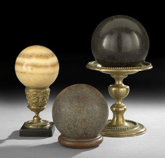 Three Decorative Stone Spheres: Three Decorative Stone Spheres, the black granite sphere resting on a continental mid-19th century brass stand, h. 11", dia. 5-3/4", the tan agate sphere resting on a Renaissance revival brass and mar