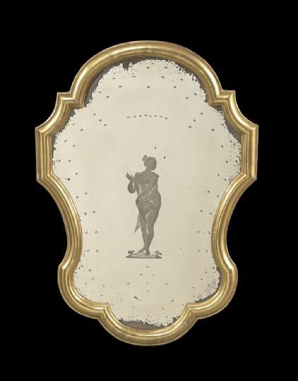 Gilt Framed Venetian-Style Mirrored Wall Plaque: Gilt Framed Venetian-Style Mirrored Wall Plaque, the serpentine shape mirror, reverse engraved with a female figure en deshabille, bordered with reverse convex ornaments, h. 25-1/2", w. 18-1/2".