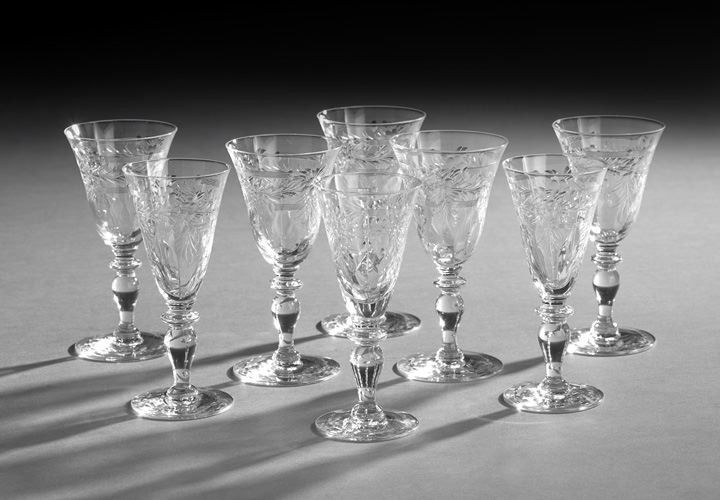 Group of Eight Wheel-Cut Crystal Stemware: Group of Eight Wheel-Cut Crystal Stemware, 20th century, cut with intaglio flowers, connected with a series of cut bands, the set comprised of five wine glasses, h. 5-1/2", and three liquor glasses, h