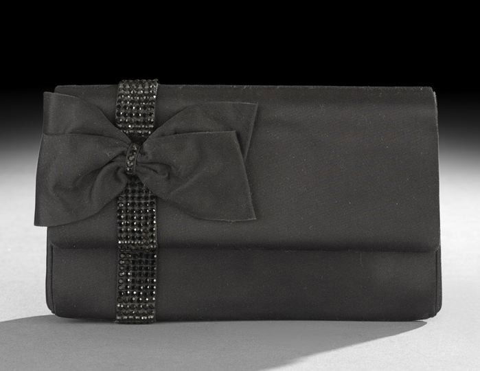 Judith Leiber Silk Satin and Jet Evening Clutch: Vintage Judith Leiber Black Silk Satin and Jet Evening Clutch, having a flat bow mounted on a band of jet stones encircling the bag at one side, the interior stamped in gilt script: "Judith Leiber" an