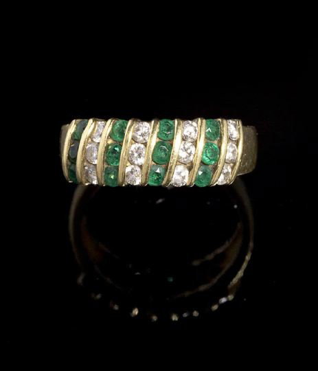 Tiffany & Co.18 Kt. Gold, Emerald & Diamond Ring: Good Tiffany and Company Eighteen Karat Yellow Gold, Emerald and Diamond Lady's Ring, designed as a band ring set diagonally with bands of round-cut diamonds and emeralds in alternating channels, size