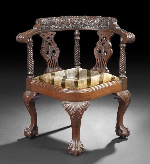 American Late Victorian Mahogany Corner Chair: Robust American Late Victorian Mahogany Corner Chair of Chippendale Influence, fourth quarter 19th century, the relief-carved back rail with a central mythological face and flaked by foliate motifs, h