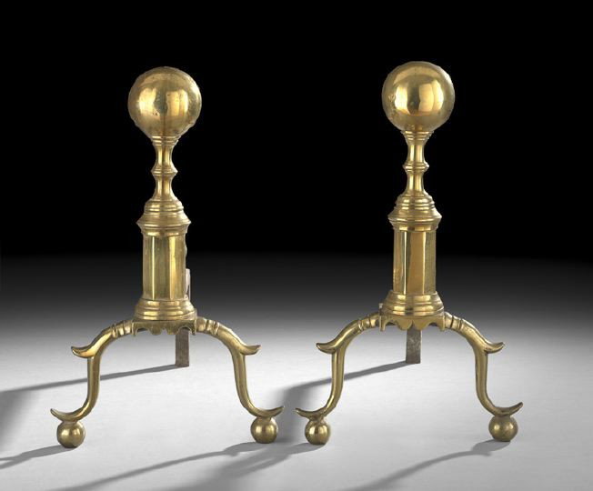 Pair of New York Late Federal Andirons: Pair of New York Late Federal Andirons, first quarter 19th century, the seamed bodies with a ball finial and the faceted plinth with a scalloped apron, with spurred ball feet and with laid iron billet