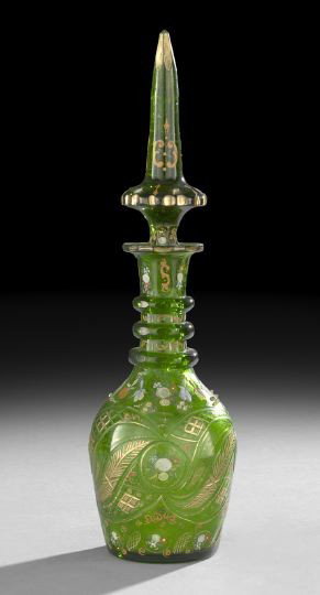 Emerald Green Bohemian Decanter: Emerald Green Bohemian Decanter, first quarter 20th century, made for the Middle Eastern market, decorated with brilliant cuts and enameled flowers and scrolls, the spear point stopper with like decor