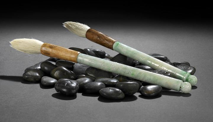 Two Chinese Carved Jadeite Calligraphy Brushes: Two Good Chinese Carved Jadeite Calligraphy Brushes, each with carved jadeite shafts of mint green color with emerald splashes and each with engraved cloud designs, the tops with bamboo bands and whit
