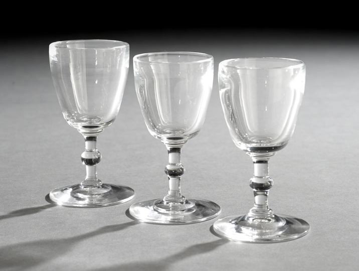 Set of Three Steuben Liquor Glasses: Set of Three Steuben Liquor Glasses, the unadorned bowls atop a stem with a central rib over a round foot, each engraved "Steuben" on the ground pontil mark, h. 4".