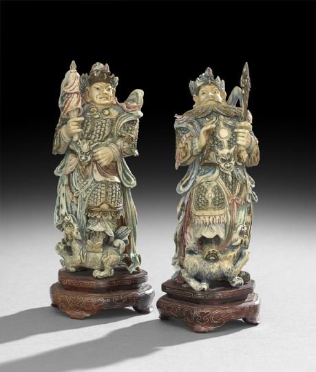 Pair of Chinese Ivory Figures of Generals: Pair of Chinese Carved and Polychromed Ivory Figures of Generals, 20th century, each figure carved in intricate detail, dressed in armor, standing on figures of lions, one figure carrying a sword, the