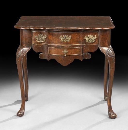 Queen Anne Figured Walnut Dressing Table: Queen Anne Figured Walnut Dressing Table, 18th century, the shaped top with highly figured veneer, above a conforming long drawer and smaller drawer below, raised on slender cabriole legs ending in ba