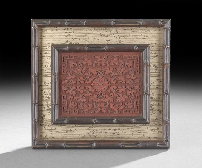 Chinese Cinnabar Panel: Chinese Cinnabar Panel, 18th century, the rectangular lacquer panel containing a central stylized peony on a field of scrollwork with square molded corners, on a stippled field, mounted in a modern ba