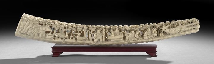 Chinese Carved and Undercut Ivory Tusk Sculpture: Unusual Chinese Carved and Undercut Ivory Tusk Sculpture, the curved end section of the tusk, carved, hollowed and undercut in intricate detail depicting a tile roofed building among clouds and trees 