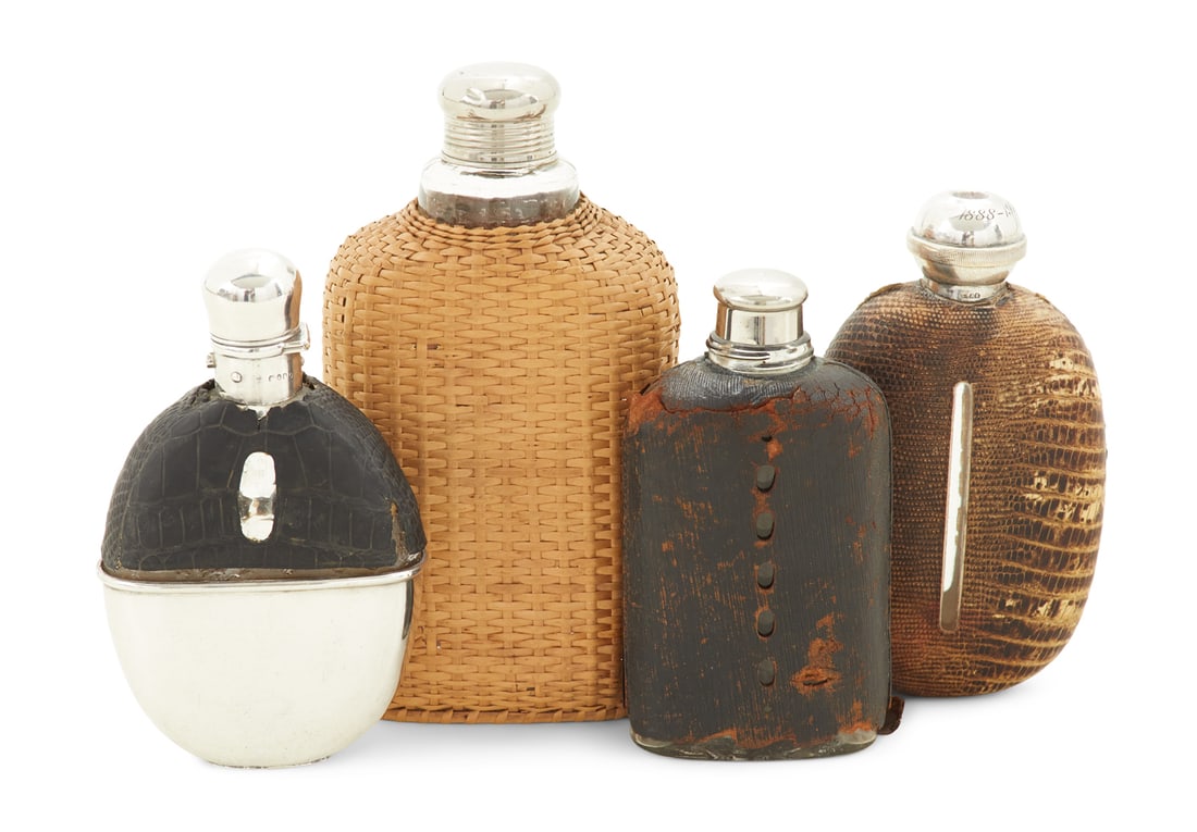 Four Covered Flasks: Four Covered Flasks including: an oval snakeskin-mounted example, Charles Westwood & Sons, Birmingham, the silverplate cap with integral collapsing shot cup, with engraved presentation date 1888-1913,